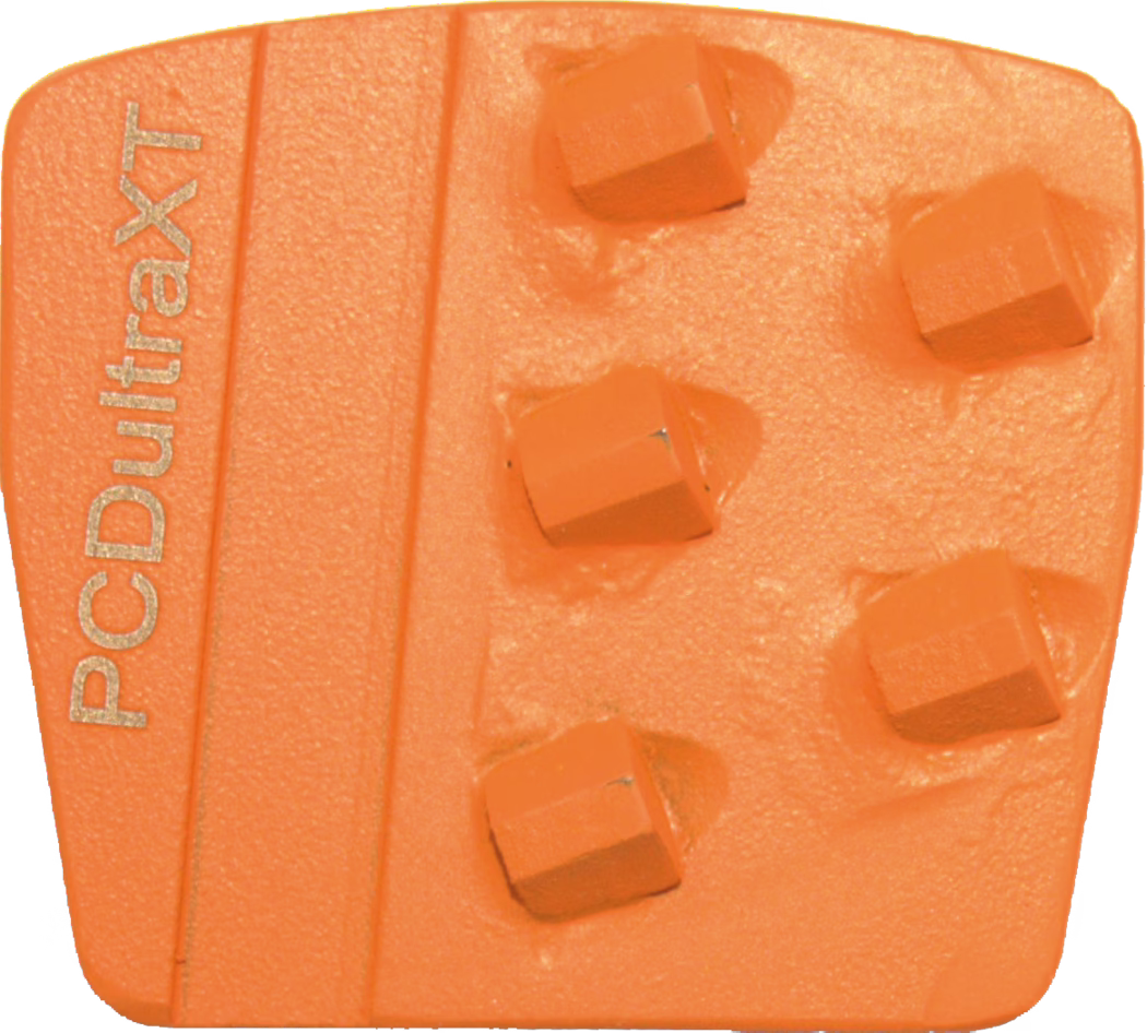 Close-up of an orange trapezoidal abrasive tool segment with a textured surface, several square-topped raised diamond inserts arranged in two offset columns, and the embossed text 'PCDUltraXT' along the left edge.